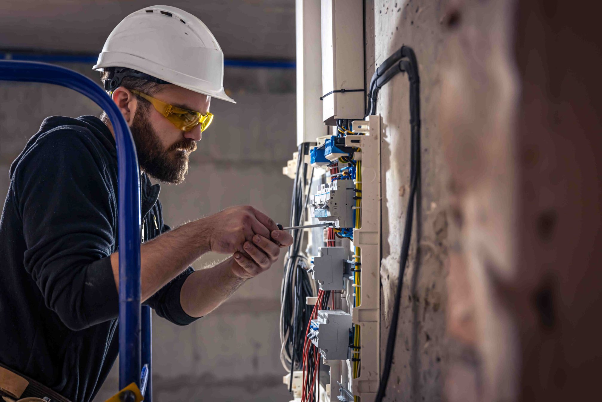 male-electrician-works-switchboard-with-electrical-connecting-cable (1) (1)